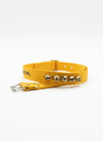 Yellow traditional ghungroo dog collar with four brass bells, designed for Indie and guard dogs, placed on a white background