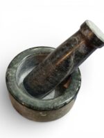 Natural stone mortar and pestle (khal batta) 4 inch wide with 4.5 inch pestle for grinding spices, herbs, and pooja materials in traditional kitchen setting.