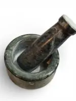 Natural stone mortar and pestle (khal batta) 4 inch wide with 4.5 inch pestle for grinding spices, herbs, and pooja materials in traditional kitchen setting.