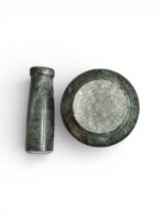 Natural stone mortar and pestle (khal batta) 4 inch wide with 4.5 inch pestle for grinding spices, herbs, and pooja materials in traditional kitchen setting.