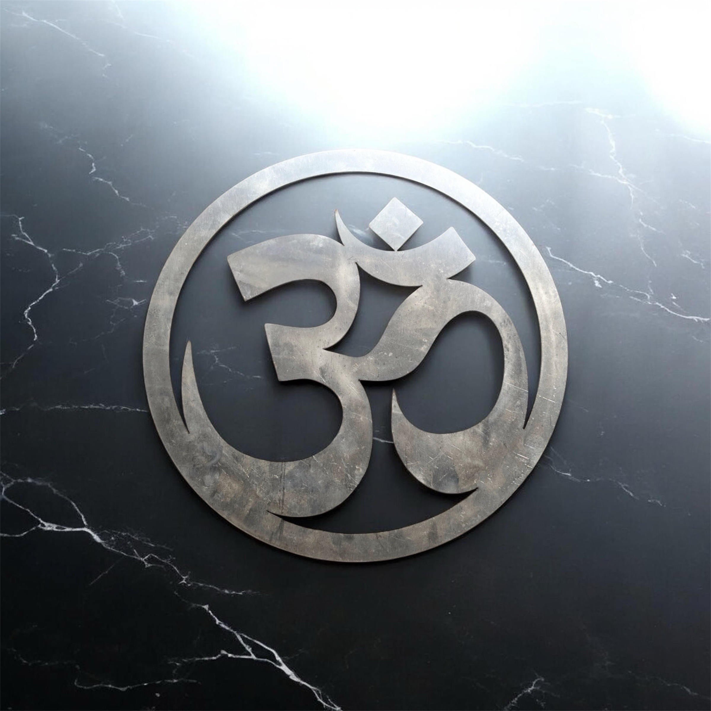 Mirror-finish stainless steel Om wall art in circular design, modern spiritual home décor piece available in 6, 8, 10, and 12 inch sizes for living room or meditation space.