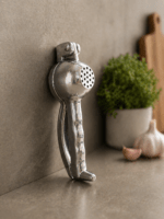 RuliaRams metal lemon squeezer with silver finish, 7.5 inch heavy duty citrus press placed on kitchen counter with fresh lemon