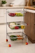 ONAM RoyalNest™ premium stainless steel 3-tier kitchen trolley with wheels featuring three spacious open-wire baskets for storing vegetables, fruits, onions, potatoes, groceries, and kitchen essentials.